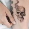 A person holding a tattoo